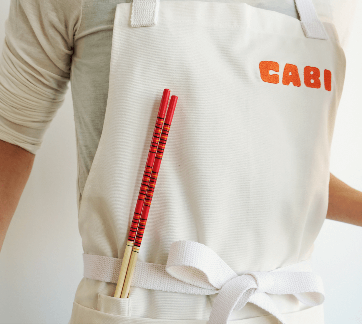 A Cabi apron with chopstics