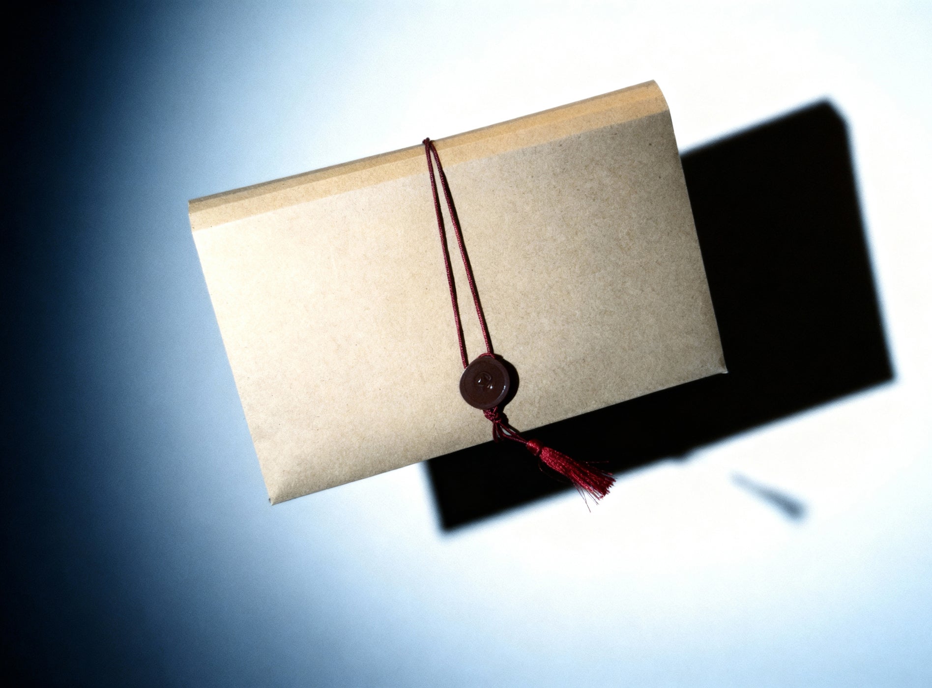 Book with a red ribbon on a gradient blue and black background